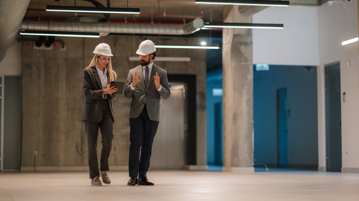 construction managers discussing project inside building