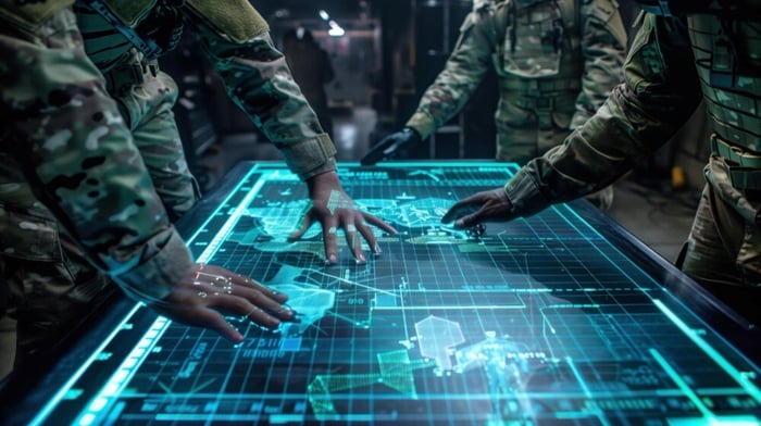 military personnel viewing large digital screen